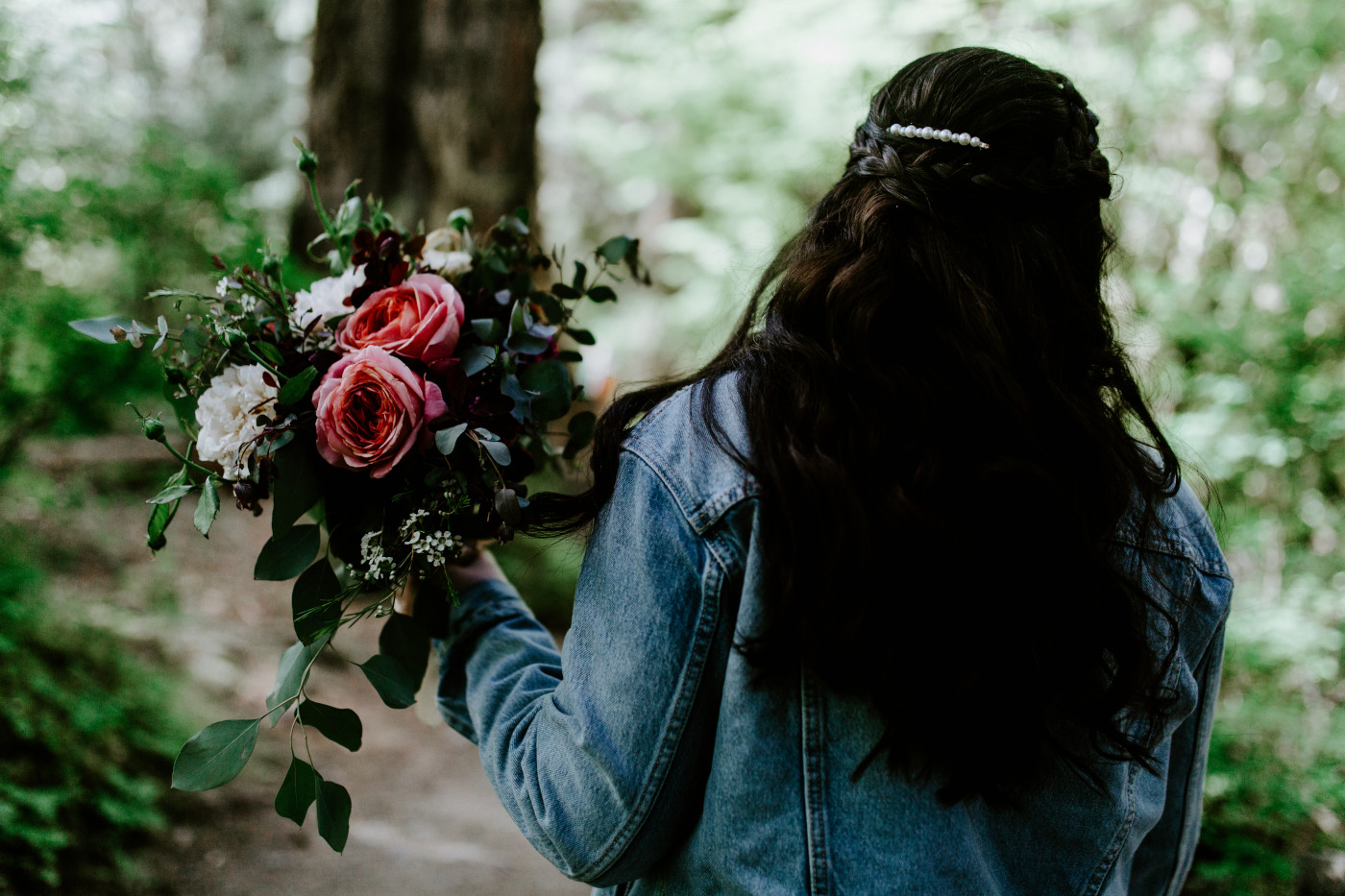 Brooke walks through the Hoh rainforest with her flowers. Elopement photography at Olympic National Park by Sienna Plus Josh.