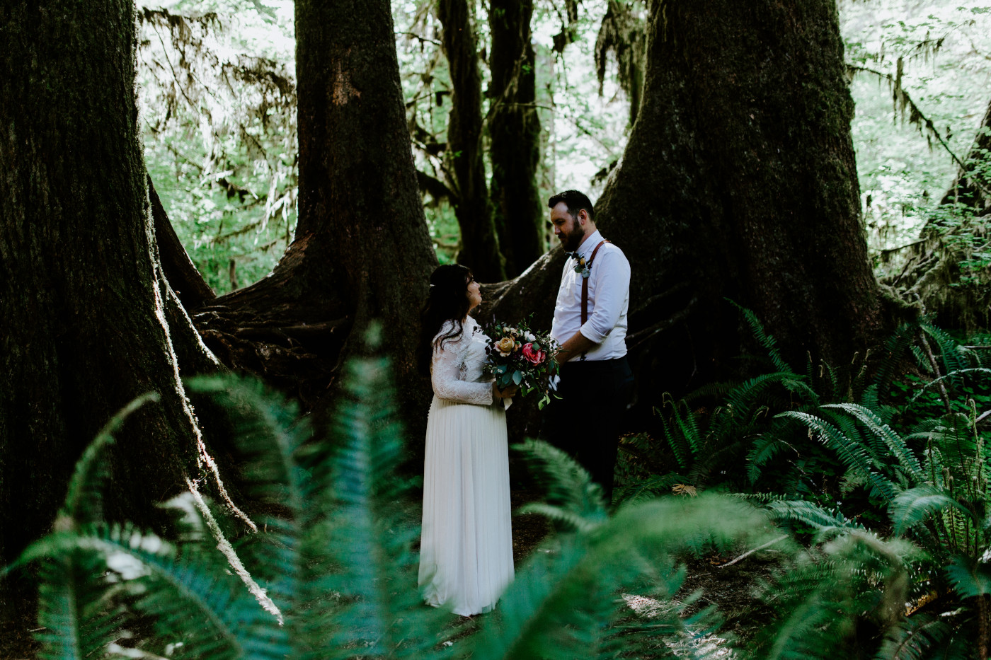 Brooke and Jack stand together in the woods. Elopement photography at Olympic National Park by Sienna Plus Josh.