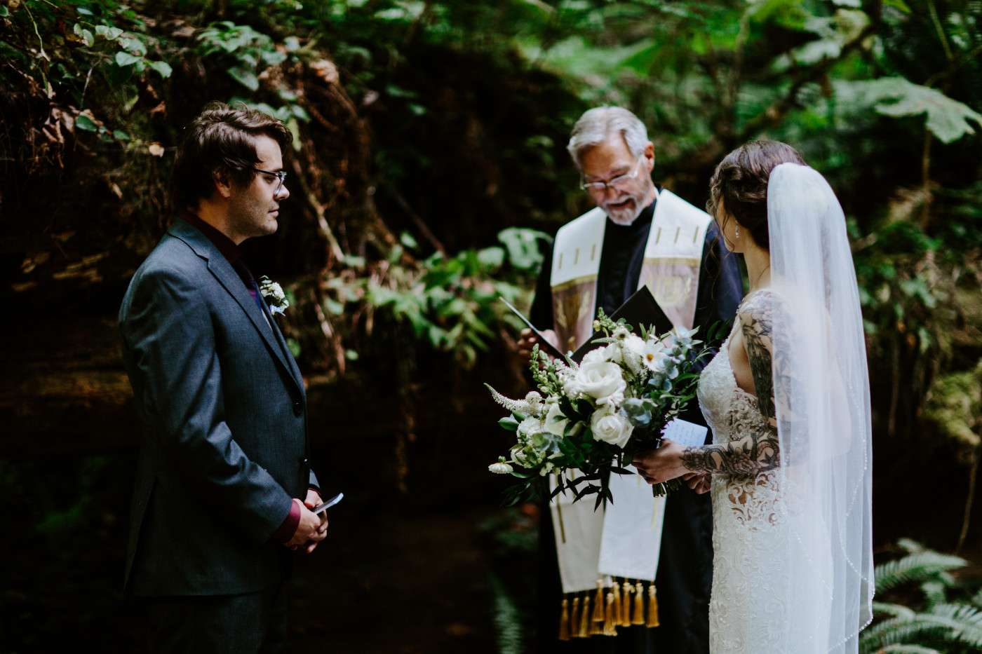 Coty and Adrielle stand together in the woods during their elopement at Olympic National Park, Washington.