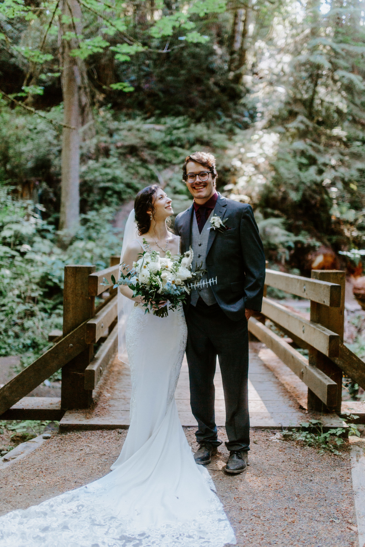 Adrielle and Coty stand together on a bridge after their elopement at Olympic National Park, Washington.