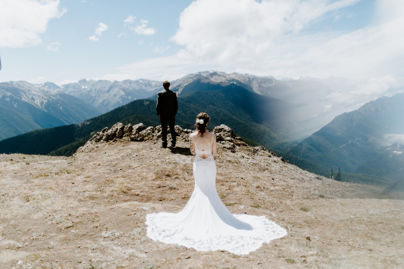 Adrielle stands in her bridal dress with Coty in the background at Olympic National Park, Washington.