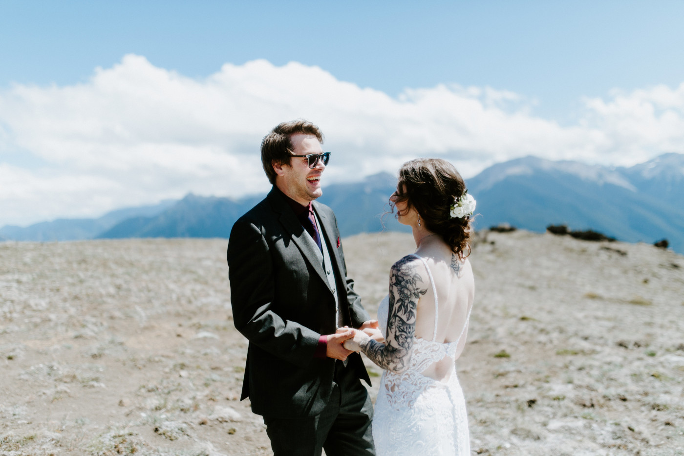 Coty and Adrielle hold hands and laugh at Olympic National Park, Washington.