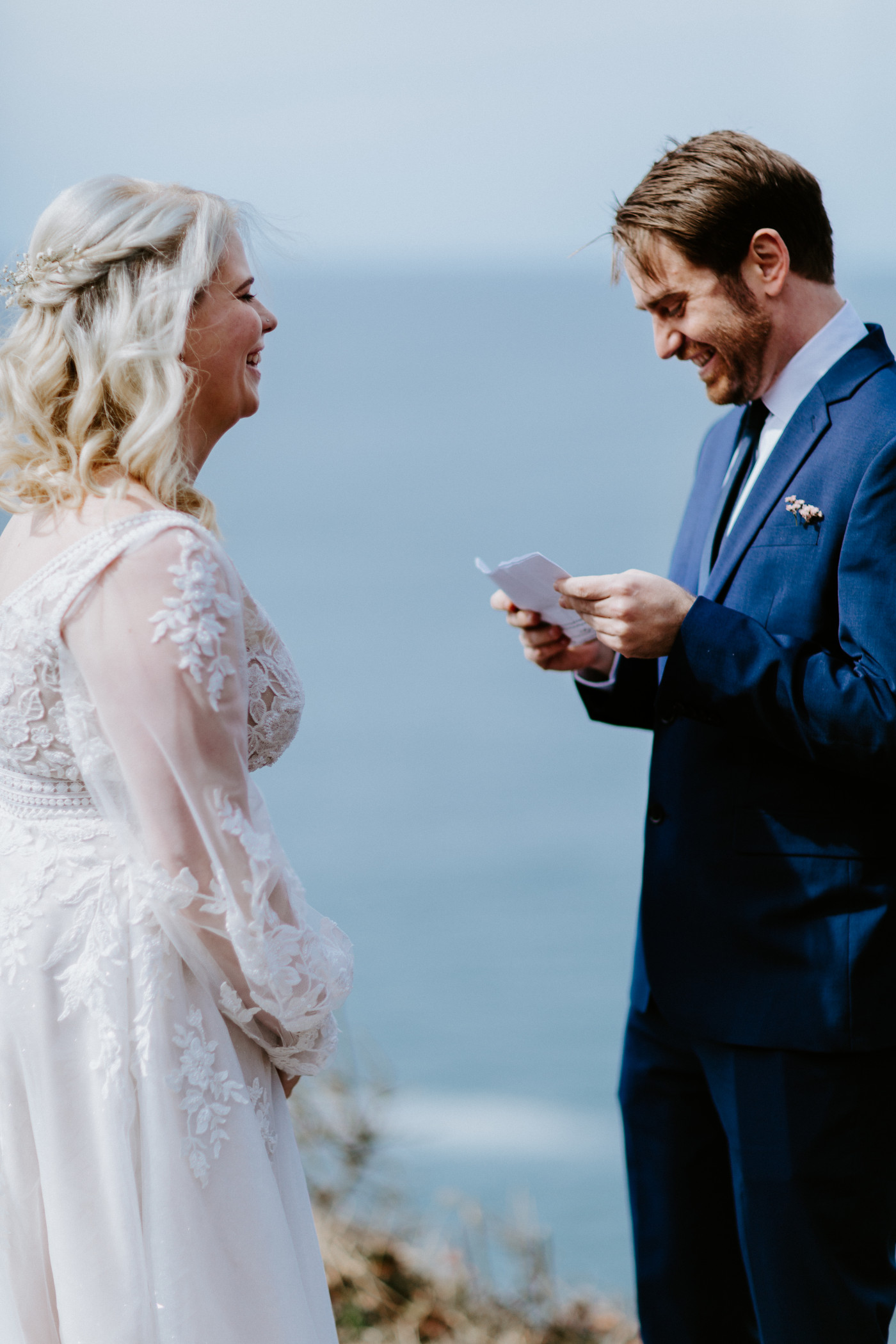 Ben recites his vows at the Oregon coast during their elopement ceremony.