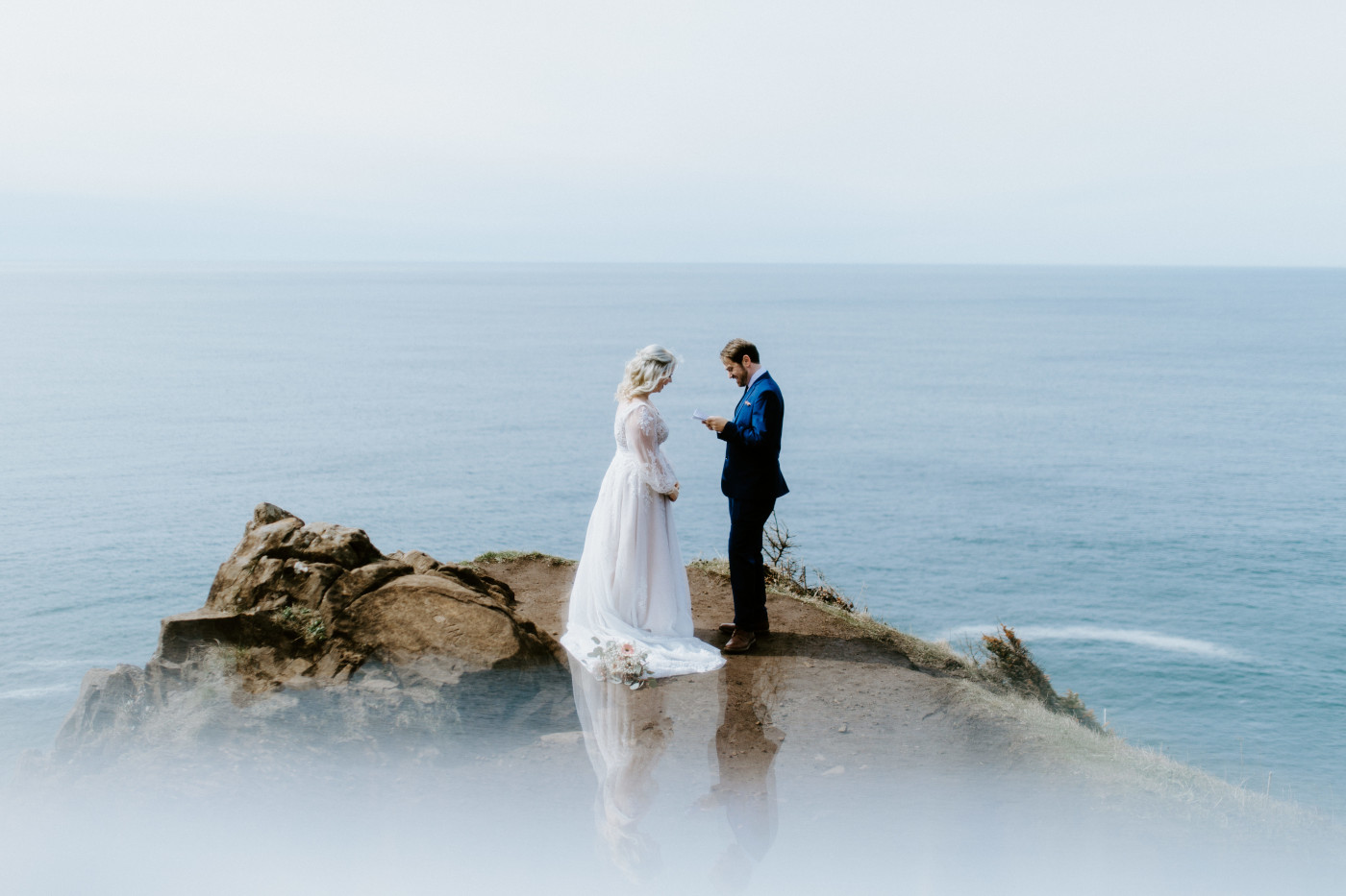 Ben recites his vows to Katie at the Oregon coast during their elopement ceremony.