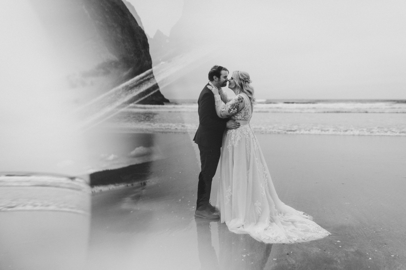 Ben and Katie go in for a kiss on the beach on the Oregon coast.