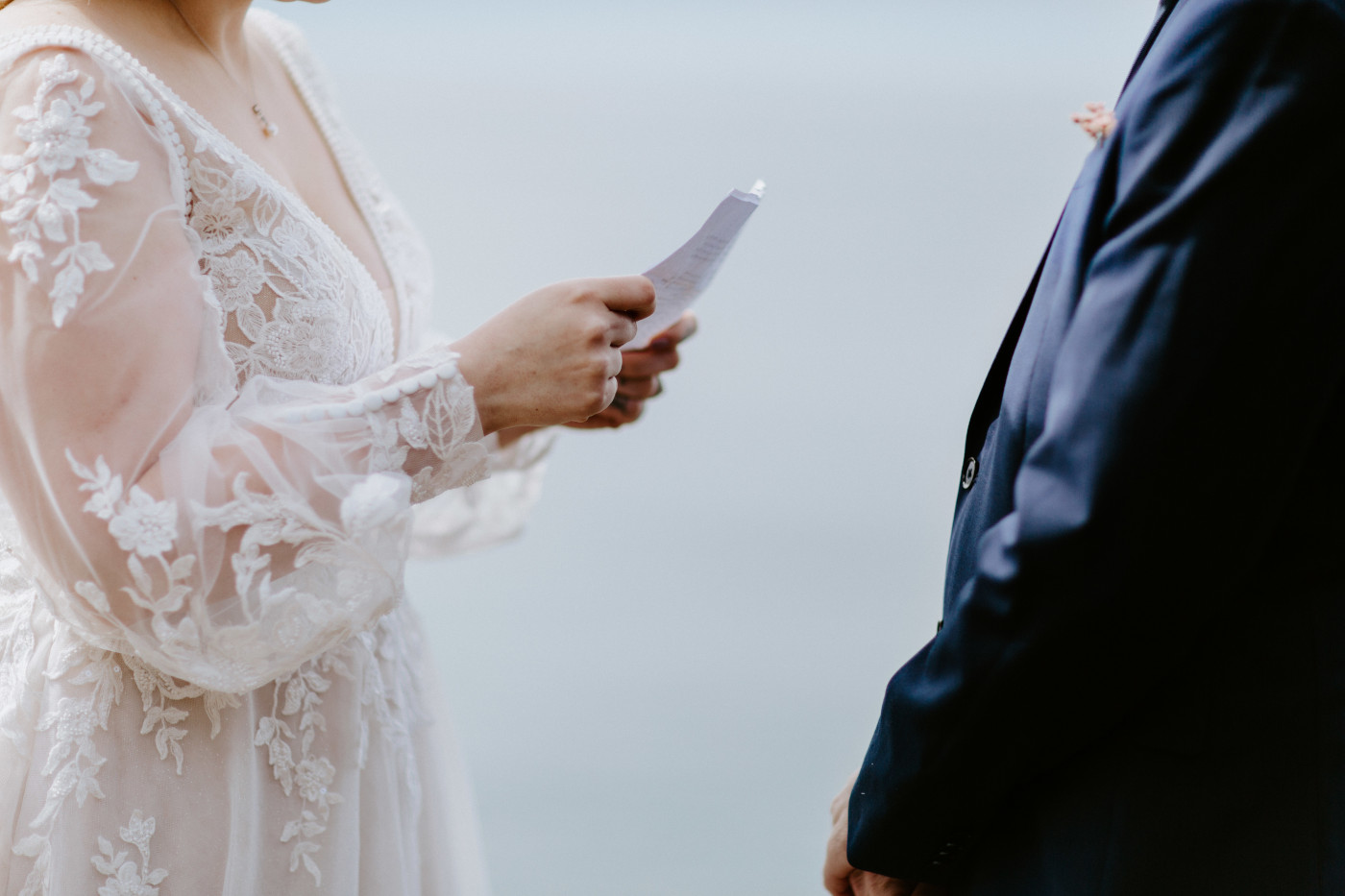 Katie recites her vows to Ben at the Oregon coast during their elopement ceremony.