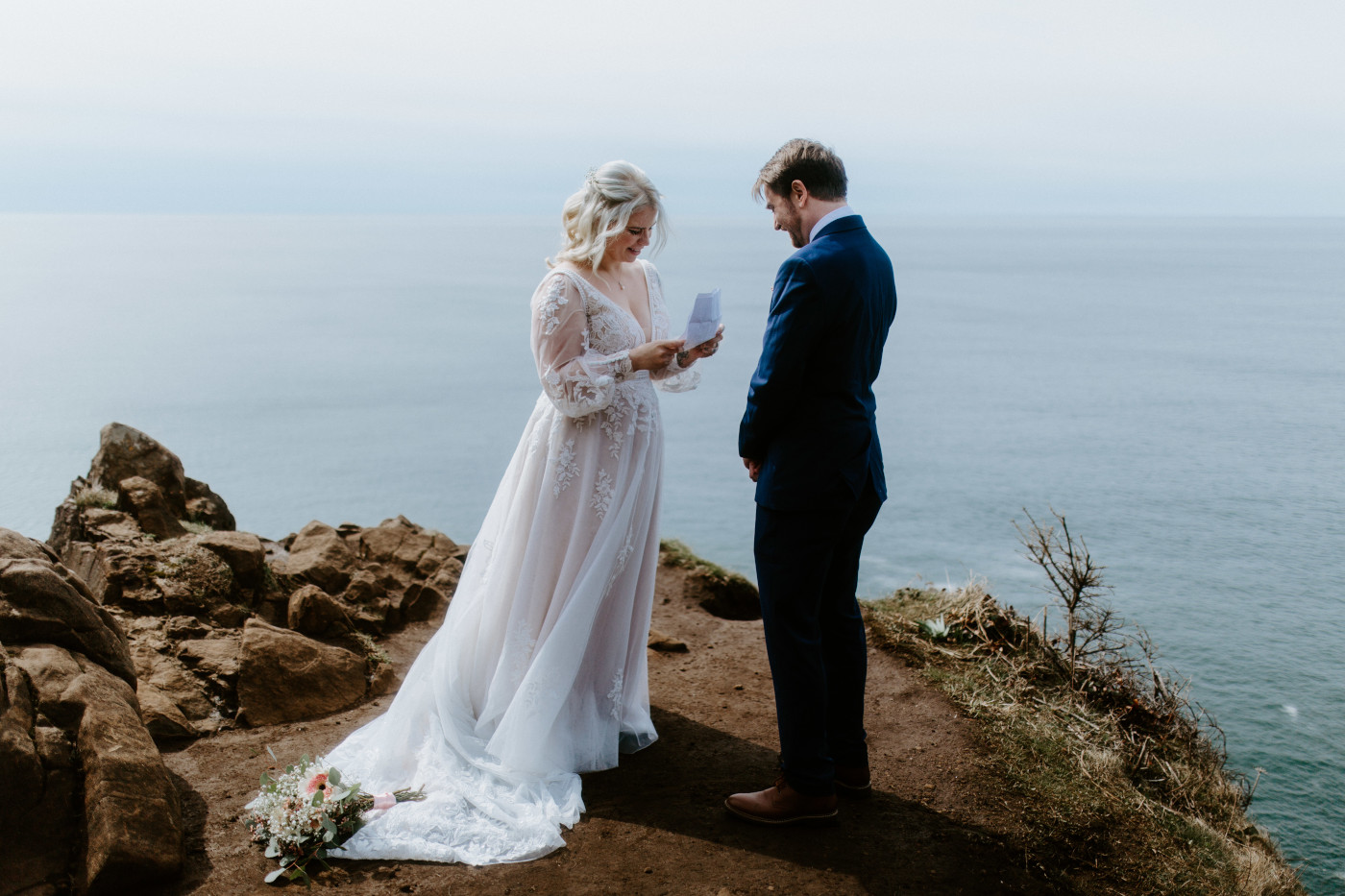 Katie recites her vows to Ben at the Oregon coast with a view of the Oregon beach.