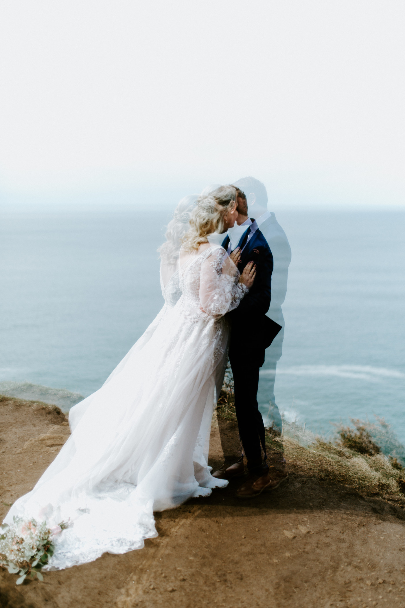 Katie and Ben kiss at the Oregon coast during their elopement ceremony.