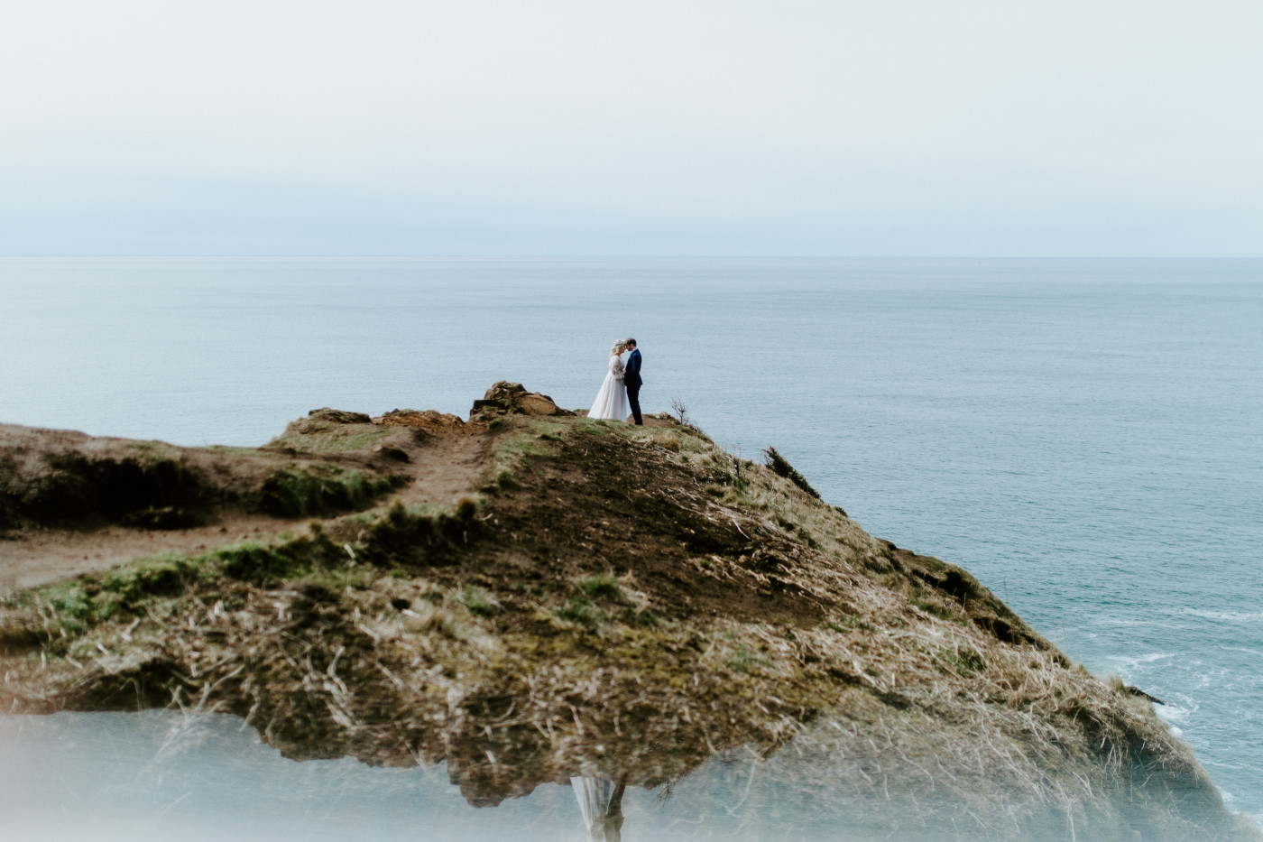 Katie and Ben stand at the Oregon coast during their elopement ceremony.