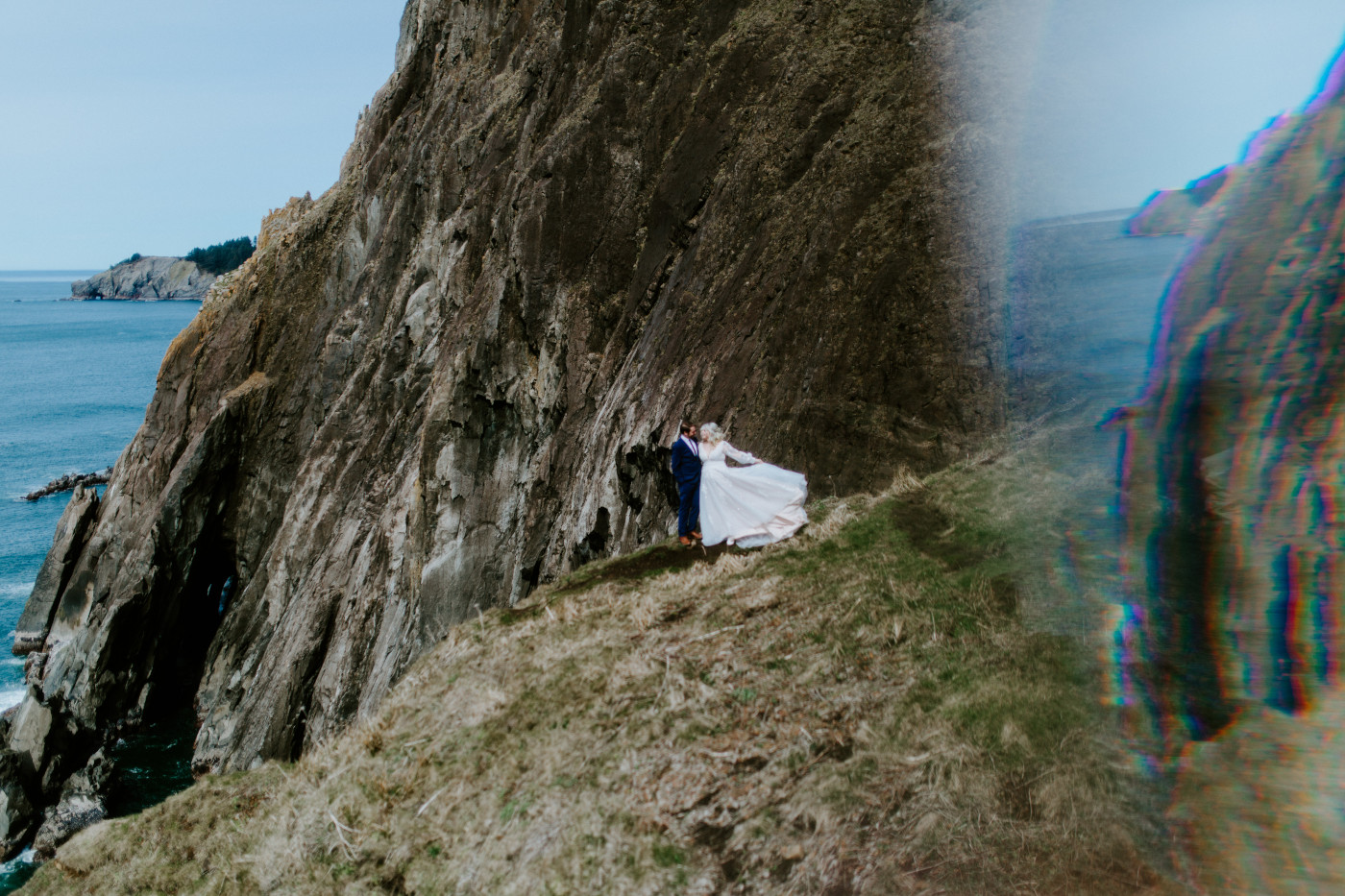 Ben and Katie stand at the Oregon cliff line after their elopement ceremony.