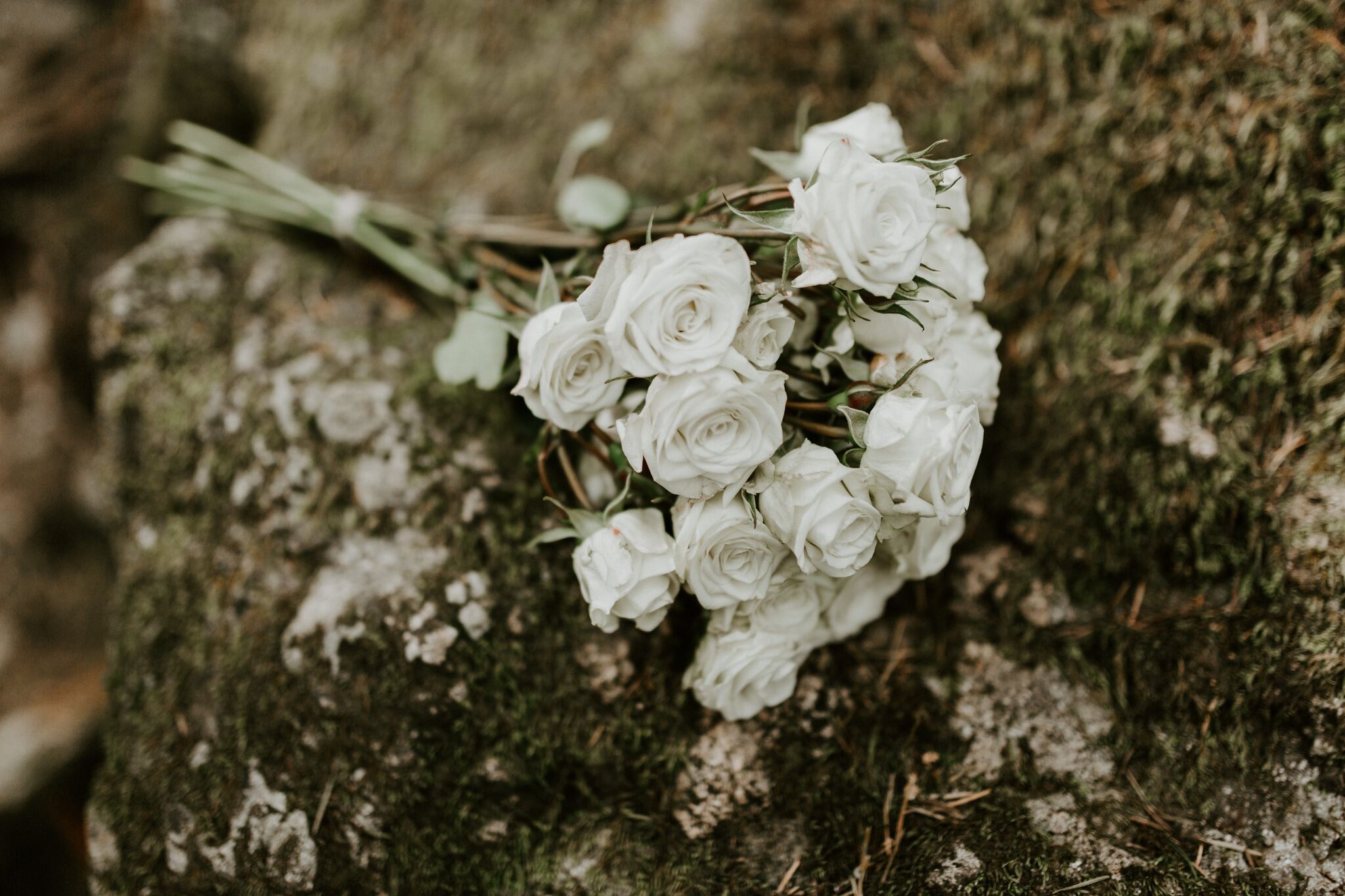 The flower bouquet laying on a rock on the trail up to Rattlesnake Ledge. Elopement adventure shoot at Rattlesnake Lake, Washington.