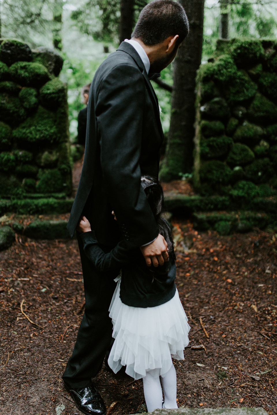 Sam hugs his daugther while they wait at Skamania House, Washington. Elopement photography in Portland Oregon by Sienna Plus Josh.