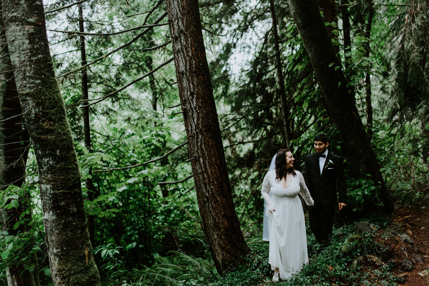Sarah leads Sam through the woods at Skamania House, Washington. Elopement photography in Portland Oregon by Sienna Plus Josh.