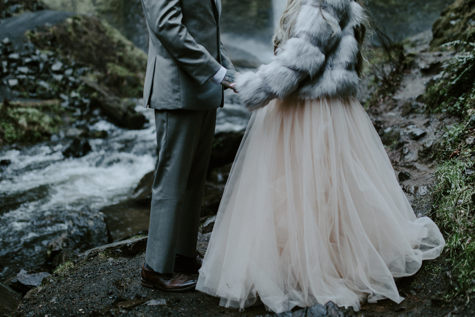 Tyanna and Boris standing near the base of Latourell Falls, OR. Adventure elopement in the Columbia River Gorge by Sienna Plus Josh.