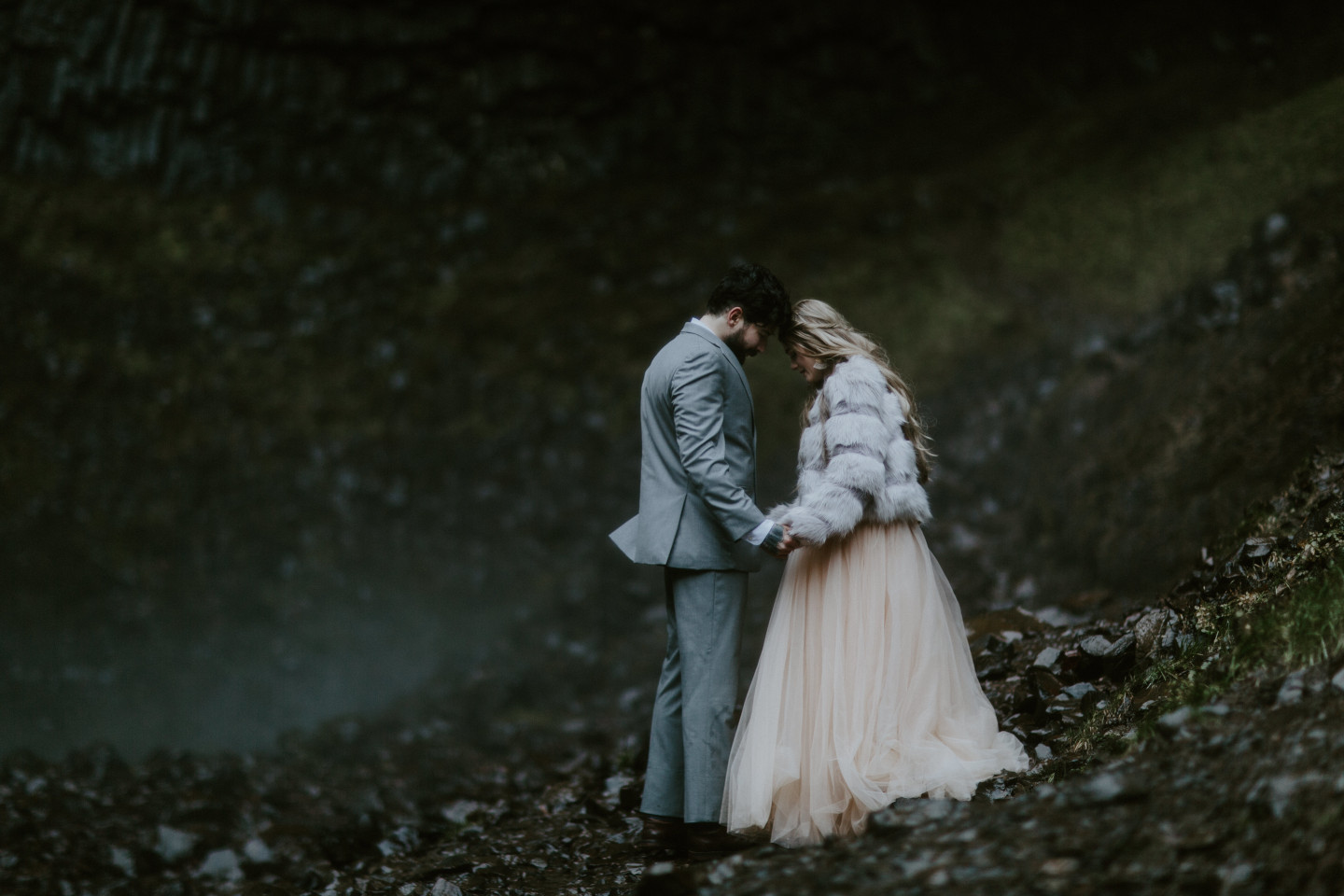 Boris and Tyanna stand forehead to forehead in front of Latourell Falls. Adventure elopement in the Columbia River Gorge by Sienna Plus Josh.