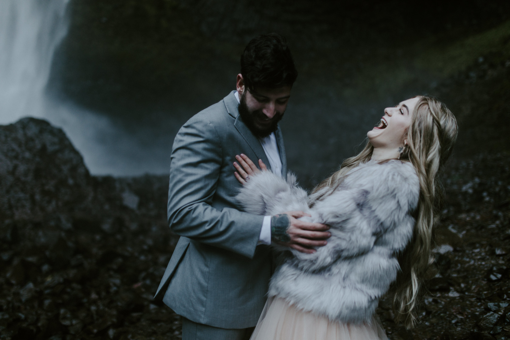 Tyanna and Boris laugh at Latourell Falls, OR. Adventure elopement in the Columbia River Gorge by Sienna Plus Josh.
