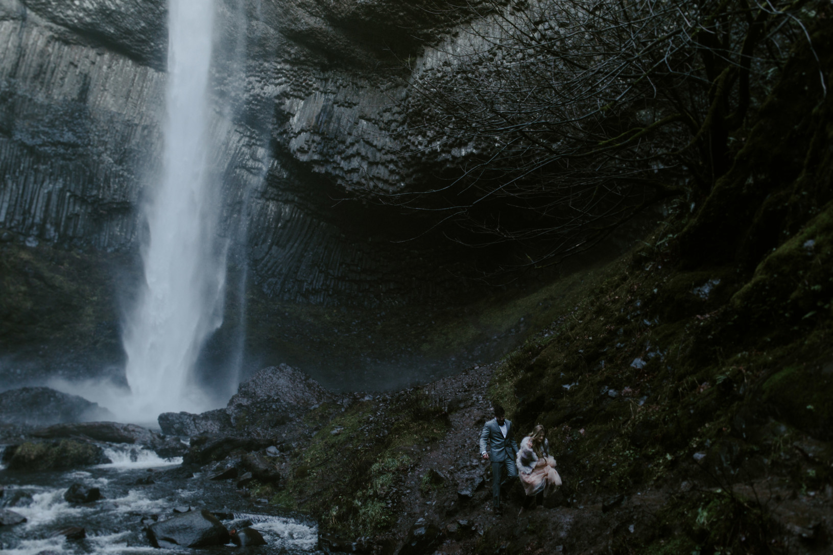 Tyanna and Boris make their way back from the base of Latourell Falls, OR. Adventure elopement in the Columbia River Gorge by Sienna Plus Josh.