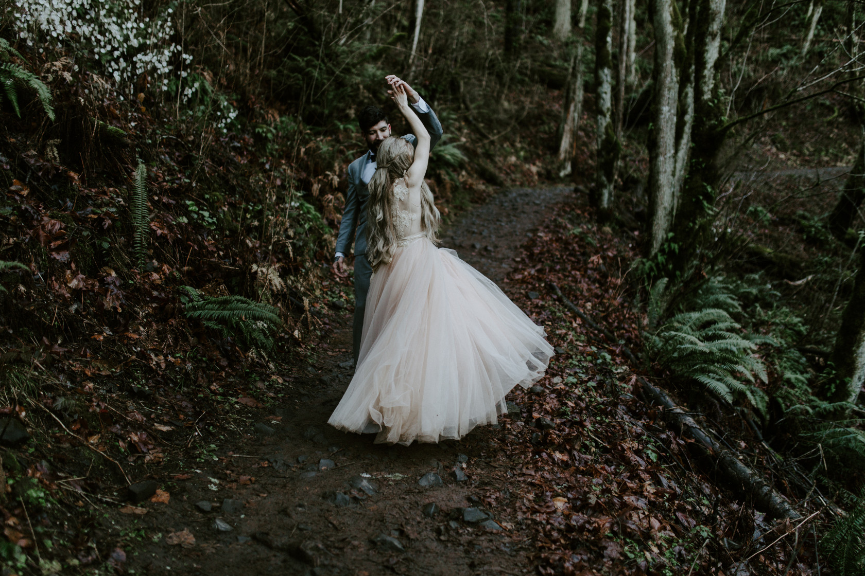 Boris spins Tyanna along a trail. Adventure elopement in the Columbia River Gorge by Sienna Plus Josh.