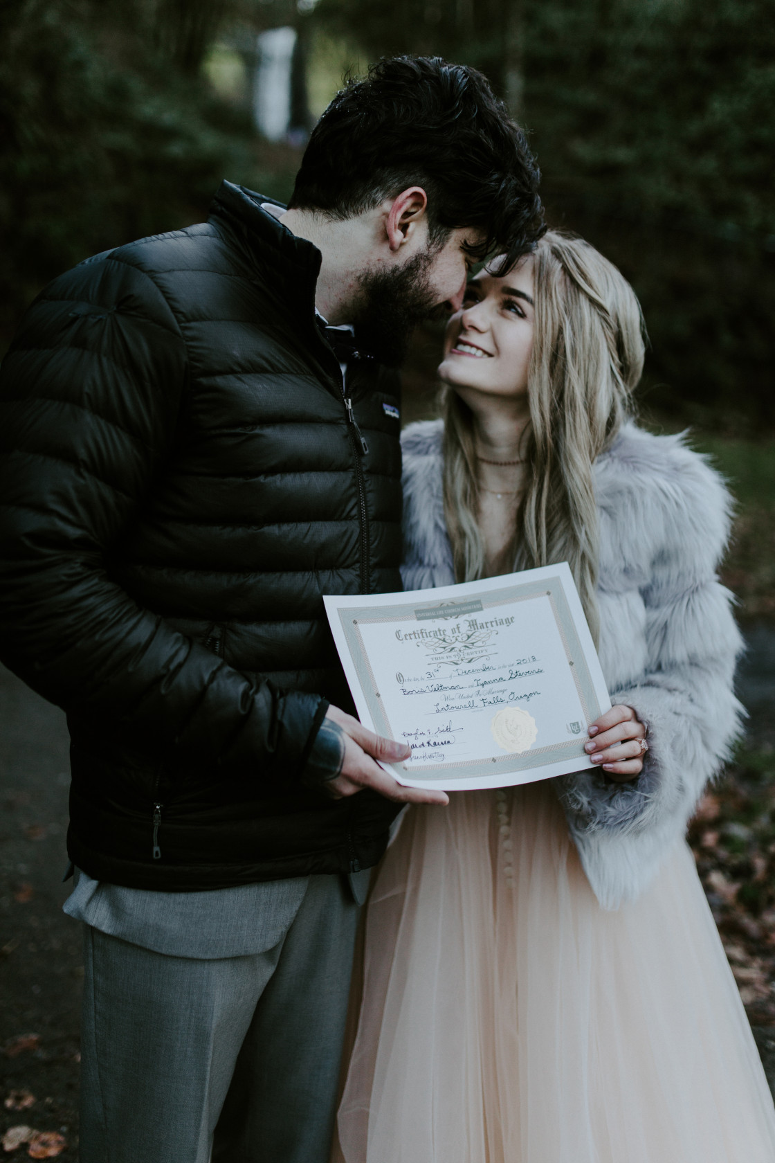 Boris and Tyanna hold their marriage certificate. Adventure elopement in the Columbia River Gorge by Sienna Plus Josh.