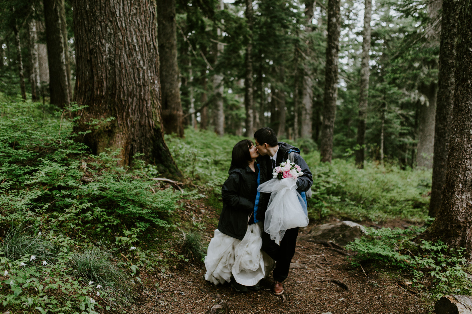 Alex and Valerie kiss as they walk toward Mount Hood in Oregon. Elopement wedding photography at Mount Hood by Sienna Plus Josh.