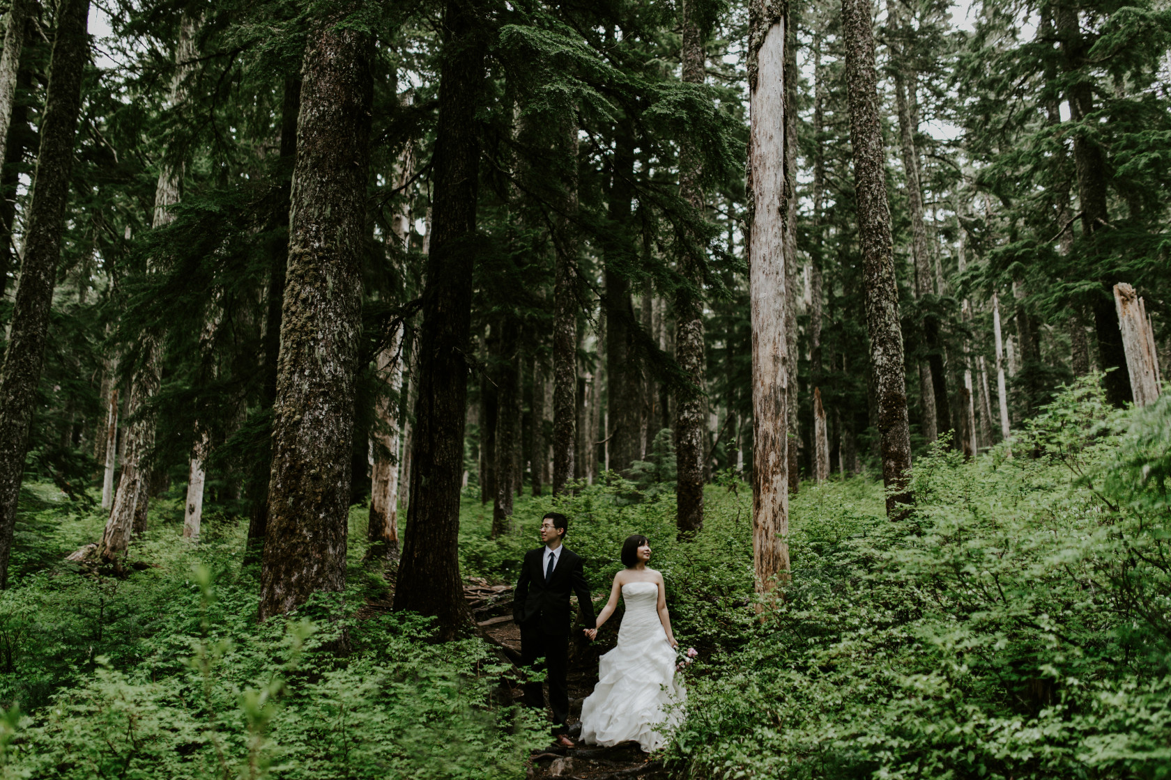 Valerie and Alex stand side by side on the trail toward Mount Hood in Oregon. Elopement wedding photography at Mount Hood by Sienna Plus Josh.