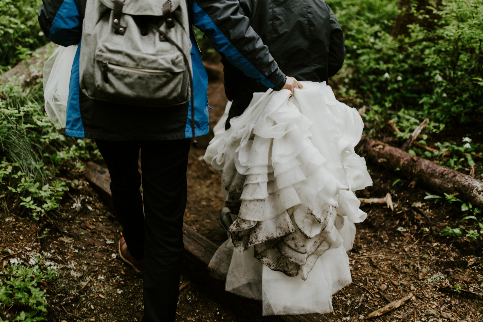 Alex holds Valerie's dress as they hike. Elopement wedding photography at Mount Hood by Sienna Plus Josh.